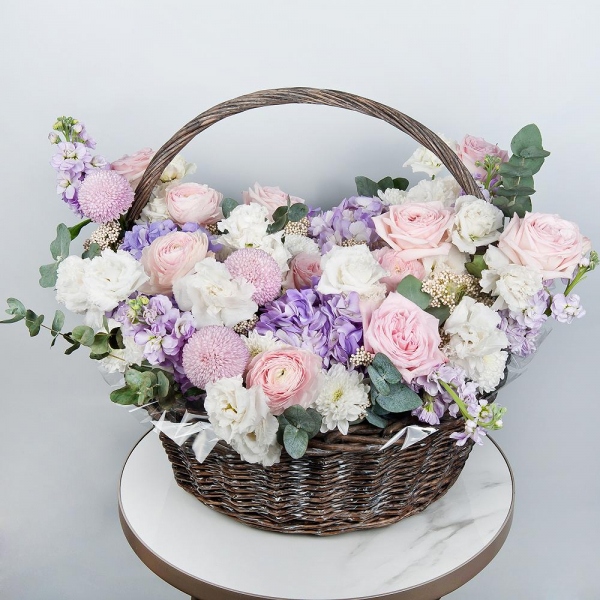 Baltica White Spray Chrysanthemum - 2, Ranunculus Pink - 5, Peony rose pink 'OHara' - 25, Blue/purple hydrangea - 3, lisianthus - 4, Matthiola Lilac - 5, Momoko Chrysanthemum - 3, Medium Basket, Oasis, Ozotamnus, Eucalyptus