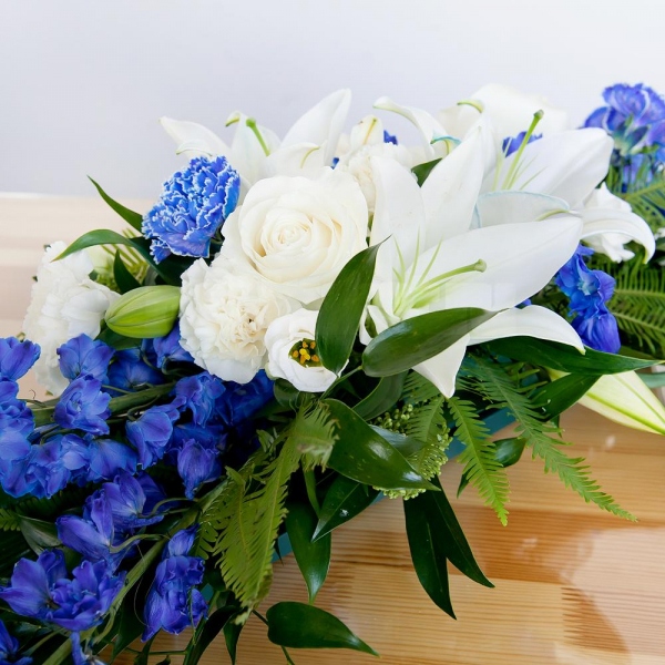 Blue carnation - 4, White rose 50 cm - 5, lisianthus - 4, Lilies - 2, Carnation white, cream - 5, Pot for compositions, Oasis, Blue Delphinium, Ambrella, Ruscus italian, Aspidistra (1 pc.), Skimmia