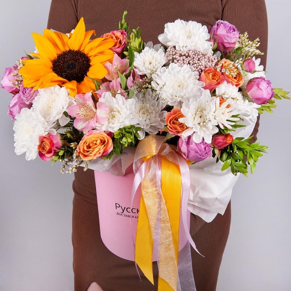 Sunflower - 1, Alstromeria white, soft pink - 4, Bright pink spray rose mix, 50 cm - 2, Baltica White Spray Chrysanthemum - 2, Spray rose: yellow, orange 50 cm - 2, Round flower box small , Oasis, Ozotamnus, Pistachio, Limonium (1 pc.), Wrapping Paper
