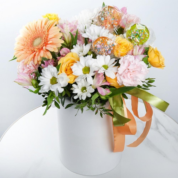 Gerbera yellow - 1, Pink carnation - 4, Alstromeria white, soft pink - 3, Bacardi White Spray Chrysanthemum - 2, Spray rose: yellow, orange 50 cm - 1, Round flower box small , Ribbon, Oasis, Pistachio, Topper (for flowers)