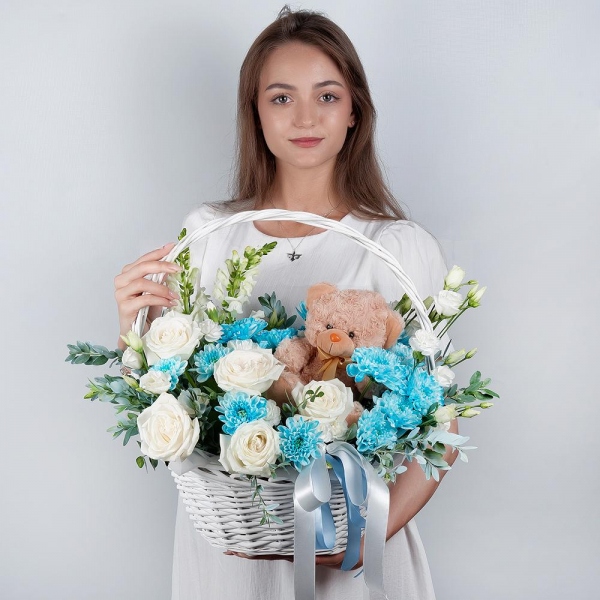 White Matthiola - 2, White rose 50 cm - 7, Chrysanthemum spray Baltica painted blue - 3, White spray carnation - 3, lisianthus - 2, Medium Basket, Oasis, Pistachio, Teddy bear 20 cm, Ribbon