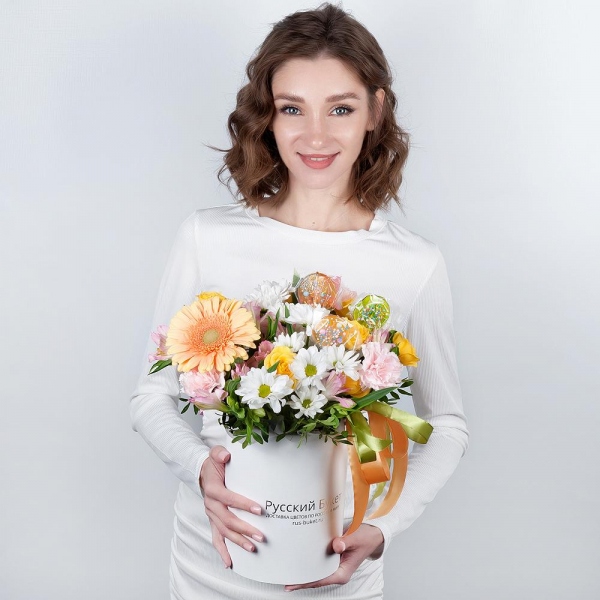 Gerbera yellow - 1, Pink carnation - 5, Alstromeria white, soft pink - 4, Bacardi White Spray Chrysanthemum - 2, Spray rose: yellow, orange 50 cm - 2, Round flower box small , Ribbon, Oasis, Pistachio, Topper (for flowers)
