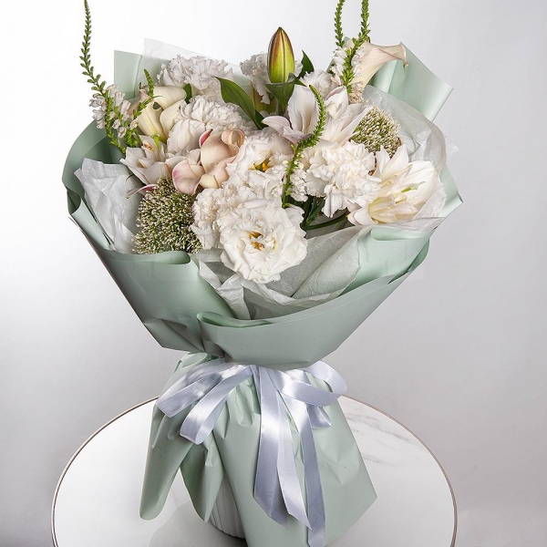 Lilies - 2, Calla lilies - 3, Carnation white, cream - 7, lisianthus - 3, Veronica spray, Sedum, Wrapping Paper