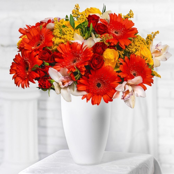 Gerbera daisies - 10, White Cymbidium Orchid Bud - 9, Spray rose: red 50 cm - 7, Yellow rose 50 cm - 7, Flask for orchids, Solidago (1 pc.), Pistachio, Mesh (Abaka), Ribbon