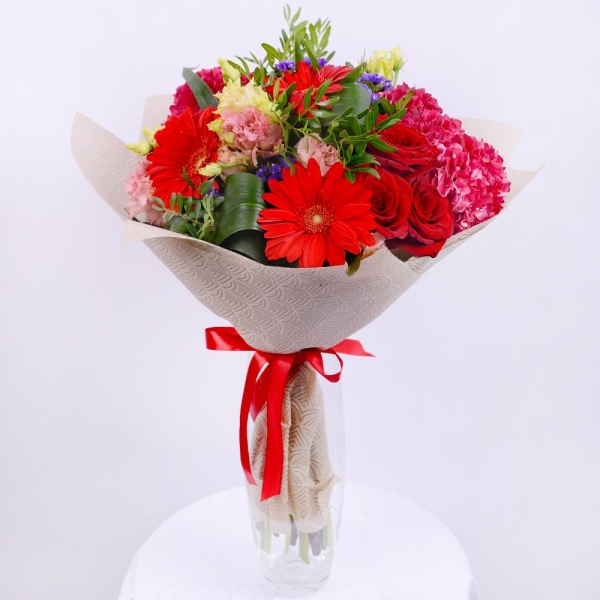 Pink Hydrangea - 3, lisianthus - 5, Gerbera red - 4, Red rose 50 cm - 4, Aspidistra (1 pc.), Blue Statice, Pistachio, Felt, Ribbon