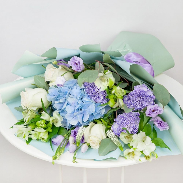 Blue/purple hydrangea - 2, Lilac carnation - 4, Alstromeria white, soft pink - 4, Purple Lisianthus (Eustoma) - 3, White rose 50 cm - 4, Veronica spray, Eucalyptus populus (1 pc.), Wrapping Paper