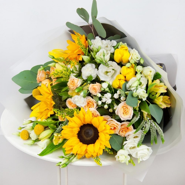 Sunflower - 4, Spray rose: white, cream, light pink 50 cm - 4, lisianthus - 4, Alstromeria Yellow, Orange - 4, Yellow tulip - 7, White spray carnation - 3, Solidago (1 pc.), Veronica spray, Craspedia, Pistachio, Eucalyptus populus (1 pc.),  Bouvardia, Wrapping Paper