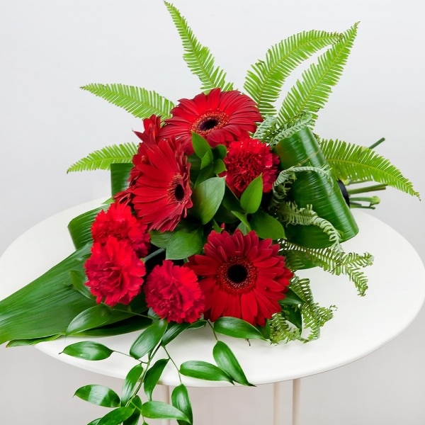 Carnation red - 6, Gerbera red - 6, Ambrella, Ruscus italian, Ruscus, Aspidistra (1 pc.), Ribbon