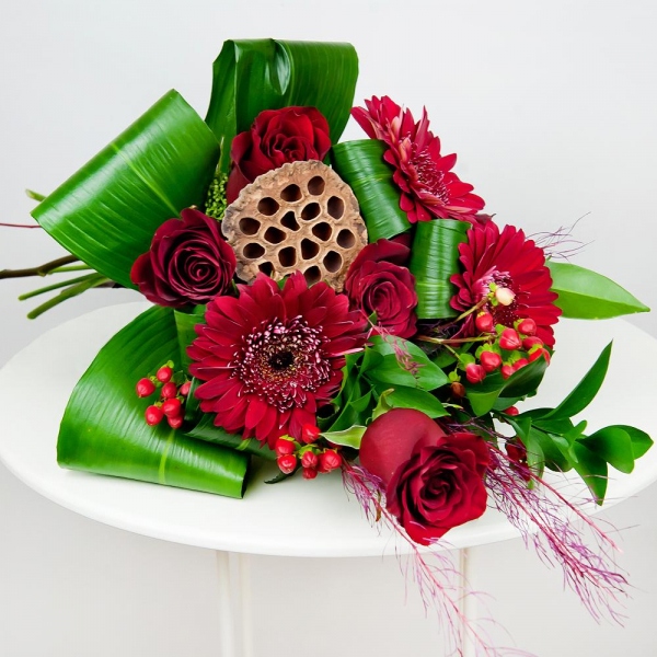 Red rose 50 cm - 7, Gerbera red - 4, Ruscus, Aspidistra (1 pc.), Hypericum, Dried flowers decor, Skimmia, Ribbon