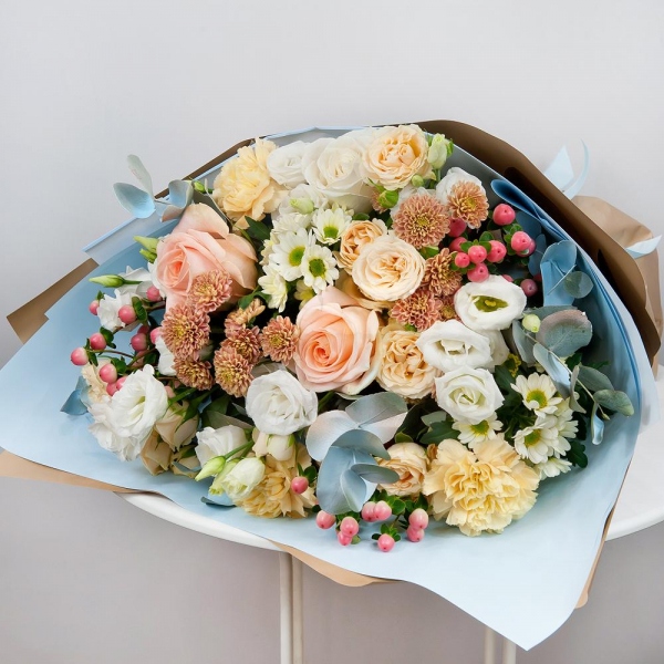 White rose 50 cm - 2, Rose Cream 50 cm - 4, Spray rose: white, cream, light pink 50 cm - 4, lisianthus - 4, Carnation white, cream - 5, Daisy poms Santini pink, purple - 4, Santini White Spray Chrysanthemum - 4, Hypericum, Eucalyptus Cinerea, Wrapping Paper
