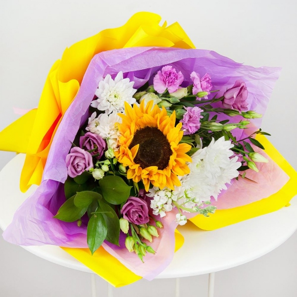 Baltica White Spray Chrysanthemum - 2, Pink Lisianthus (Eustoma) - 3, Pink spray carnation - 2, Sunflower - 1, White Matthiola - 1, Pistachio, Ruscus, Wrapping Paper