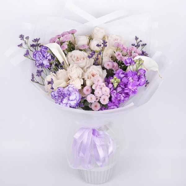 Peony style roses - 5, Calla lilies - 3, Carnation white, cream - 4, Peony sprayrose - 2, Matthiola Lilac - 2, Daisy poms Santini pink, purple - 3, Limonium (1 pc.), Wrapping Paper, Ribbon