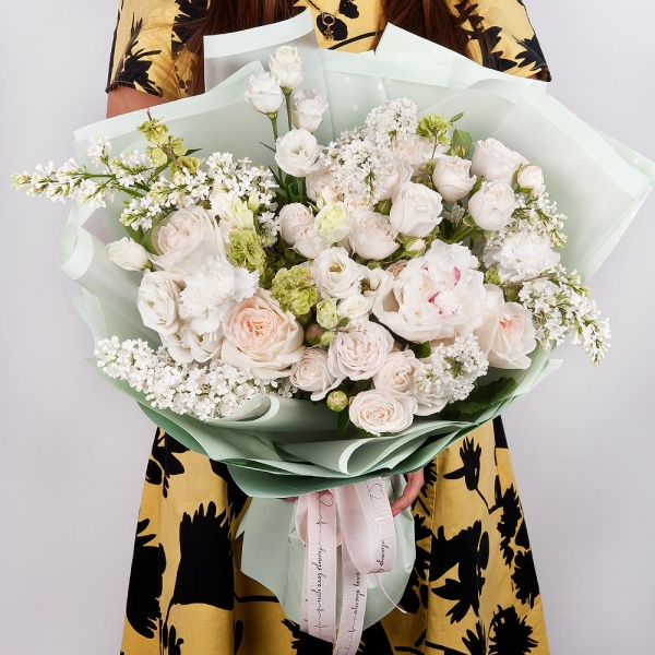 Peony white - 1, Peony style roses - 5, Peony sprayrose - 5, lisianthus - 3, Carnation white, cream - 6, White Lilac - 3, Wrapping Paper, Ribbon