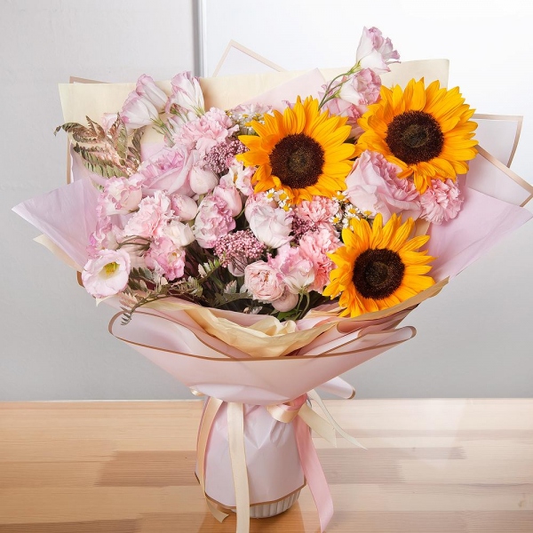 Sunflower - 3, Pink carnation - 7, Pink Lisianthus (Eustoma) - 2, Pink rose 50 cm - 5, Chamomile - 3, Peony sprayrose - 3, Ozotamnus, Fern (1 pc.), Wrapping Paper