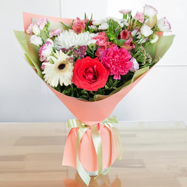 Magnum White Chrysanthemum - 1, Gerbera white - 1, Pink carnation - 2, Santini White Spray Chrysanthemum - 2, Bright pink spray rose mix, 50 cm - 1, Alstromeria white, soft pink - 3, Red rose 50 cm - 1, Pink Lisianthus (Eustoma) - 2, Pink spray carnation - 2, Ozotamnus, White statice, Pistachio, Wrapping Paper