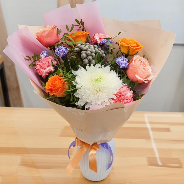 Magnum White Chrysanthemum - 1, Orange carnation - 4, Pink spray carnation - 2, Peony rose Kahala 50 cm - 2, Multicolor rose 50 cm - 4, Brunia Green Lanuginosa (1 pc.), Pistachio, Wrapping Paper, Ribbon