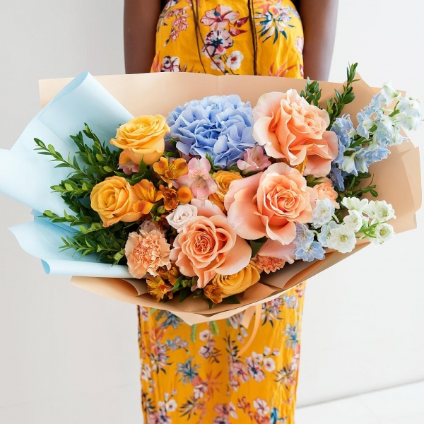 Blue/purple hydrangea - 1, Cream Rose 50 cm Ecuador (Creme Caramel) - 3, Rose Cream 50 cm - 5, Spray rose: white, cream, light pink 50 cm - 2, Carnation white, cream - 5, Alstromeria Yellow, Orange - 3, Alstromeria white, soft pink - 3, Blue Delphinium, Pistachio, Wrapping Paper