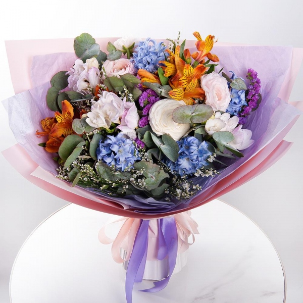 Blue Hyacinth - 5, Freesia - 5, Ranunculus Pink - 3, Alstromeria Yellow, Orange - 6, Limonium (1 pc.), Blue Statice, Eucalyptus, Wrapping Paper