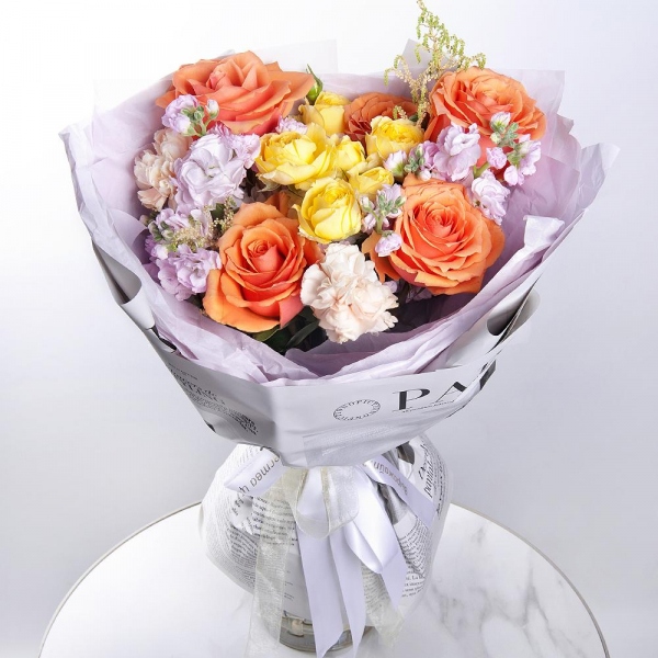 Rose Orange 50 cm Ecuador (High Magic, High Yollow Magic) - 5, Spray rose: yellow, orange 50 cm - 1, Baltica White Spray Chrysanthemum - 1, Carnation white, cream - 6, Matthiola Lilac - 2, Astilbe, Wrapping Paper