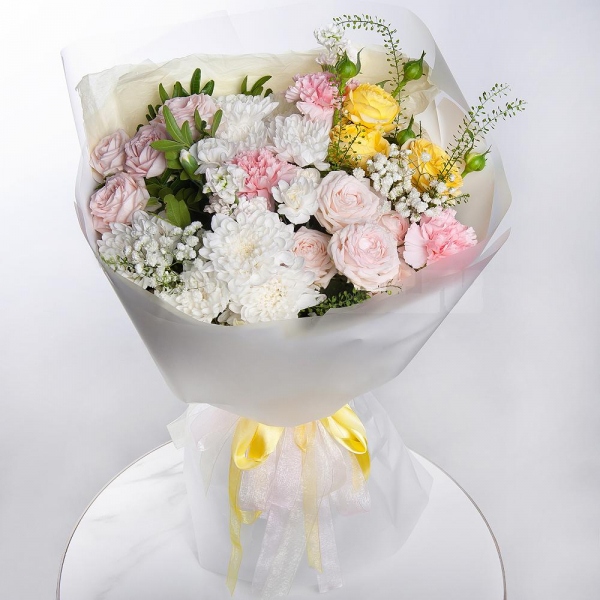 Baltica White Spray Chrysanthemum - 3, Peony sprayrose - 2, Pink carnation - 7, White spray carnation - 4, White Matthiola - 2, Gypsophila - 2, Pistachio, Green bell (1 pc.), Wrapping Paper